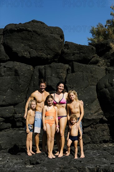 Family portrait on rocks at beach