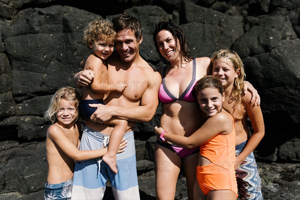 Family portrait on rocks at beach