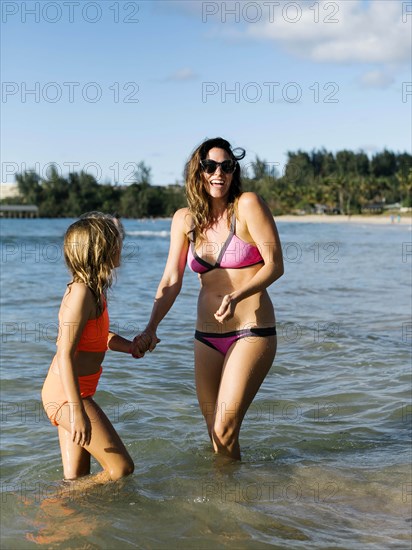 Woman with her daughter on beach