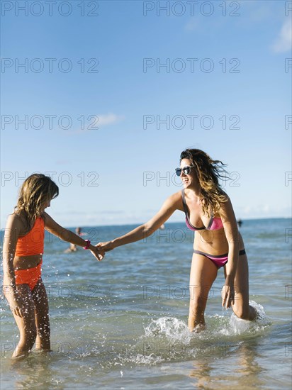 Woman with her daughter on beach