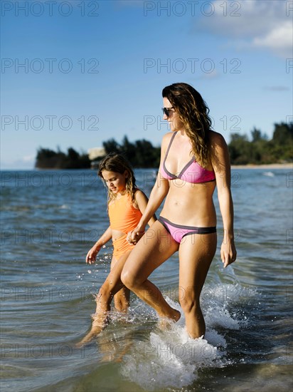 Woman with her daughter on beach