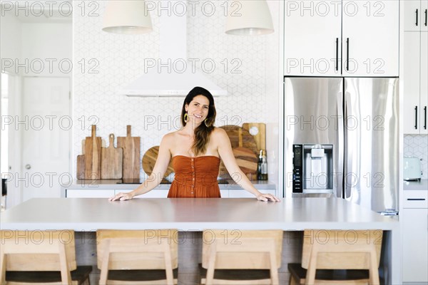 Mid adult woman smiling in kitchen