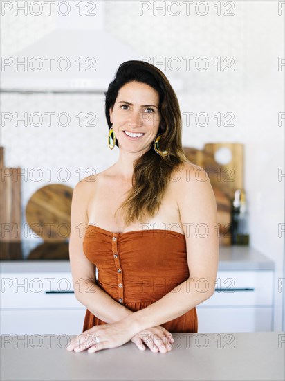 Mid adult woman smiling in kitchen