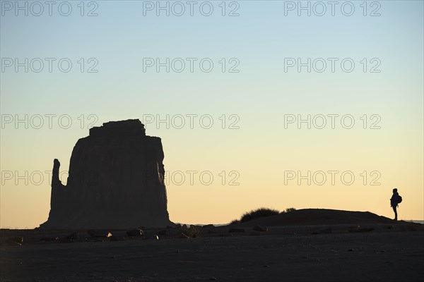 Silhouette of woman by butte in Monument Valley, Arizona, USA