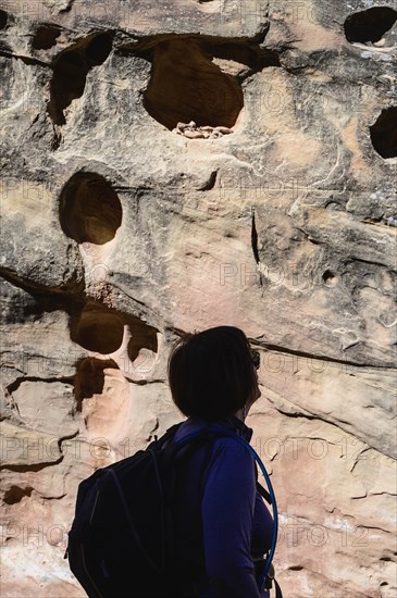 Woman in shadow by eroded rock in Capitol Reef National Park, USA