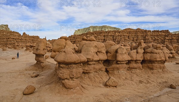 Woman hiking through Goblin Valley State Park in Utah, USA