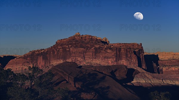 Moon over rock formation in Capitol Reef National Park, USA