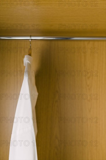 Shirts on clothes hangers in wardrobe