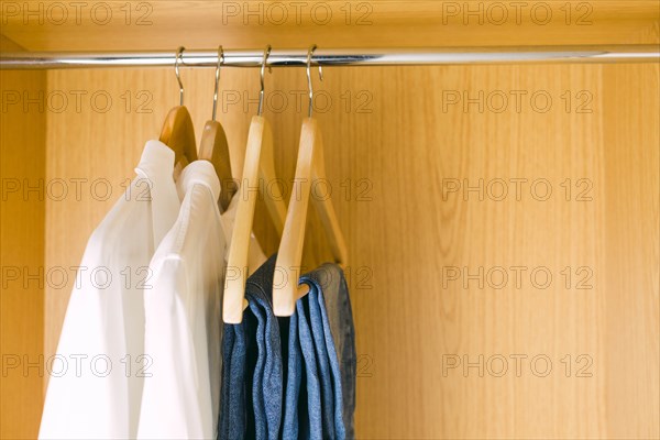 Clothes hanging in wardrobe