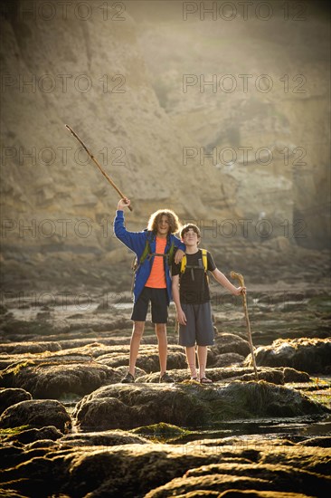 Teenage boys on rocks by tide pool in La Jolla, California