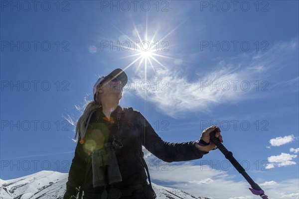 Low angle view of hiker on snow covered mountain