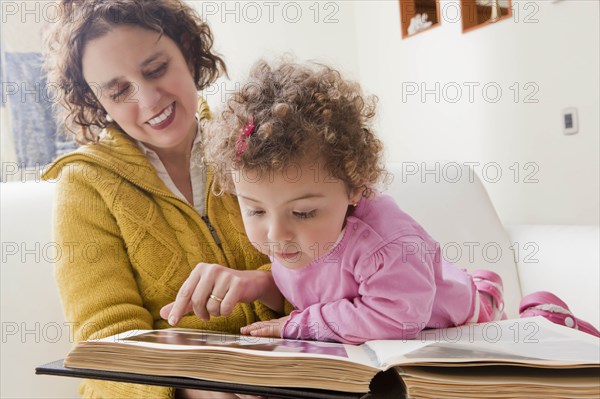 Mother and daughter reading picture book