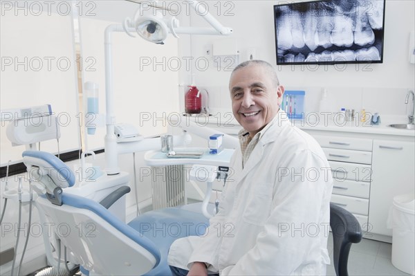 Dentist smiling in dentist's surgery
