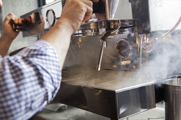 Barista using coffee machine