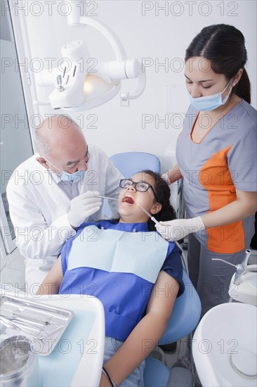 Teenage girl getting dental cleaning