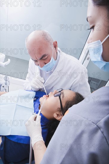 Teenage girl getting dental cleaning