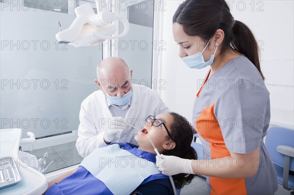 Teenage girl getting dental cleaning