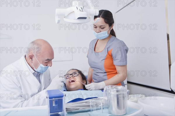 Teenage girl getting dental cleaning