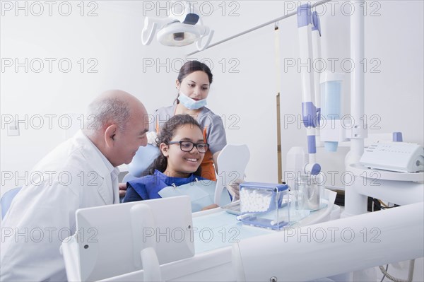 Patient smiling at mirror in dentist's surgery