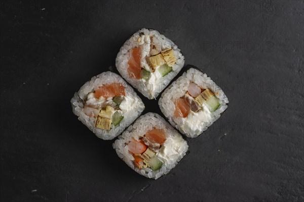 Salmon sushi on black surface