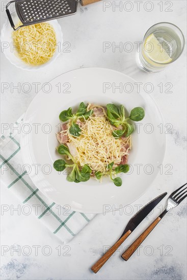 Pasta topped with cheese and basil