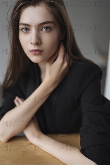 Young woman with her hand on her neck