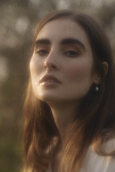 Portrait of young woman in sunlight