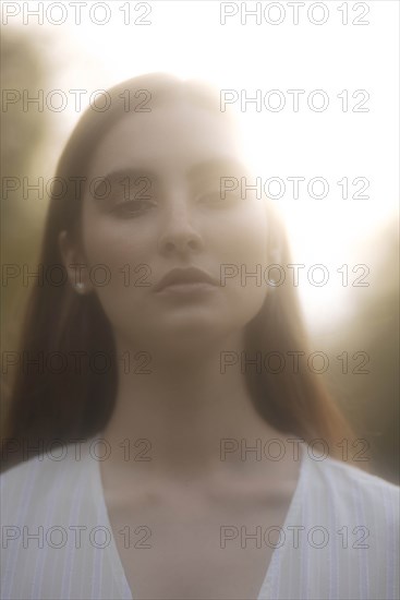 Portrait of young woman in sunlight