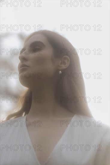 Brown haired young woman looking away