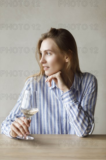 Young woman with glass of white wine