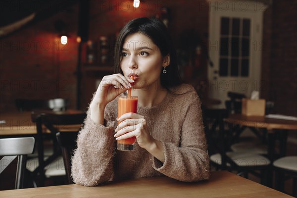 Young woman drinking juice