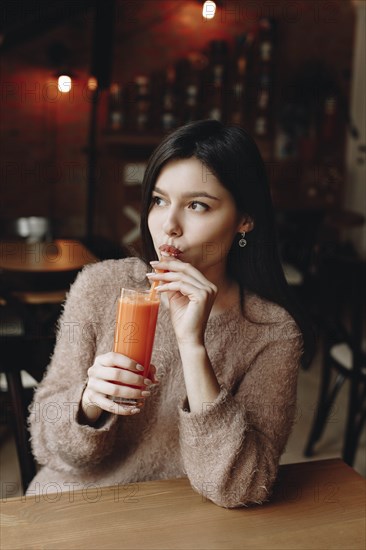 Young woman drinking juice