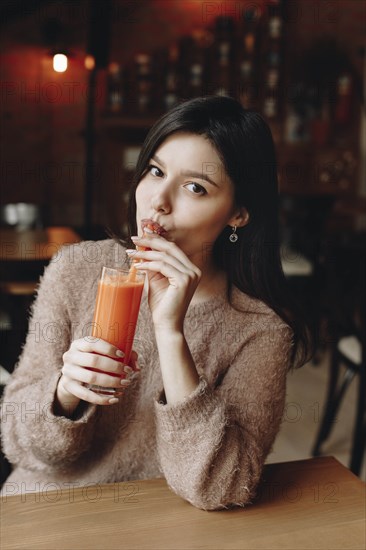 Young woman drinking juice