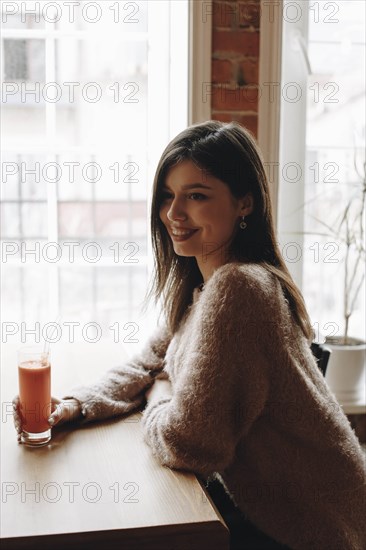 Young woman with carrot juice