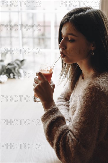 Young woman drinking juice