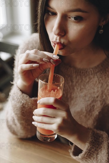 Young woman drinking juice