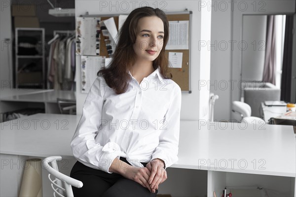 Fashion designer sitting at desk