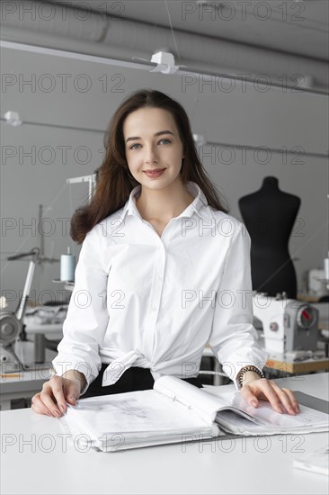 Fashion designer working at desk in studio