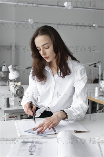 Fashion designer working at desk in studio