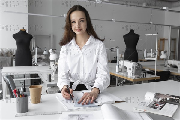 Fashion designer working at desk in studio