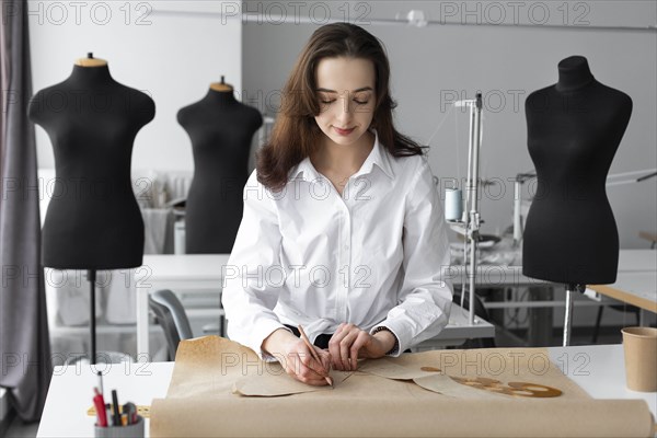 Fashion designer working at desk in studio