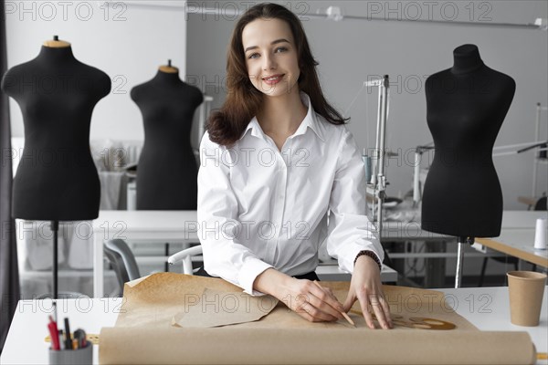 Fashion designer working at desk in studio