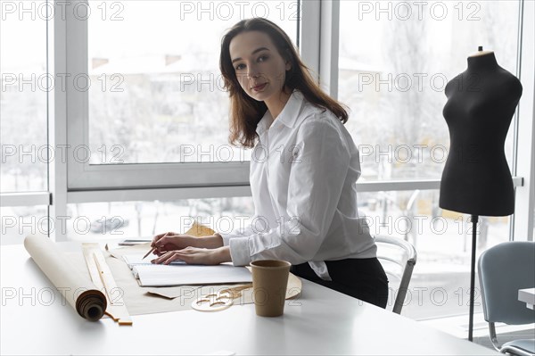 Fashion designer working at desk in studio