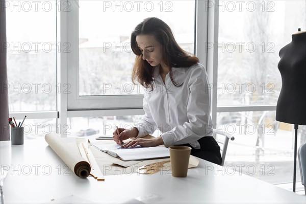 Fashion designer working at desk in studio