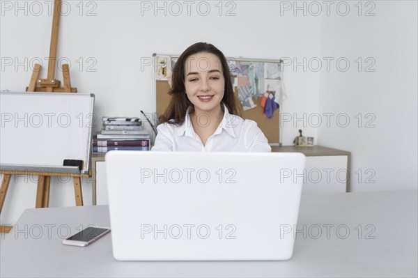 Fashion designer working at laptop