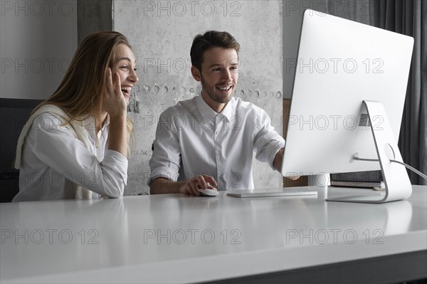 Businesspeople using computer together