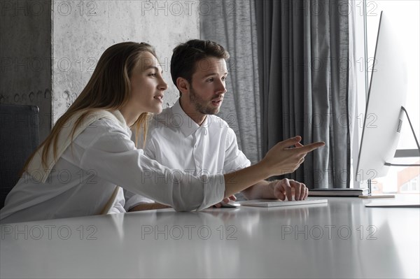 Businesspeople using computer together