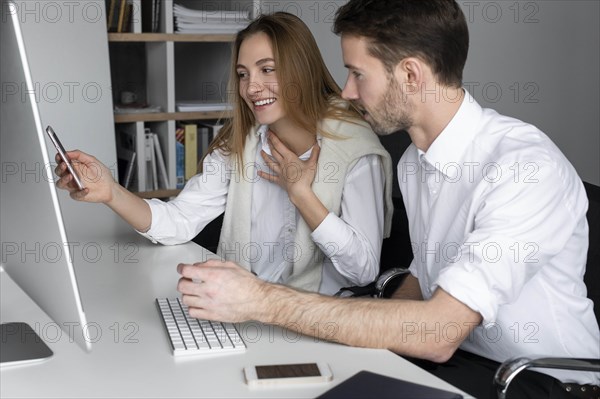 Businesspeople using computer together