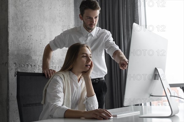 Businesspeople using computer together