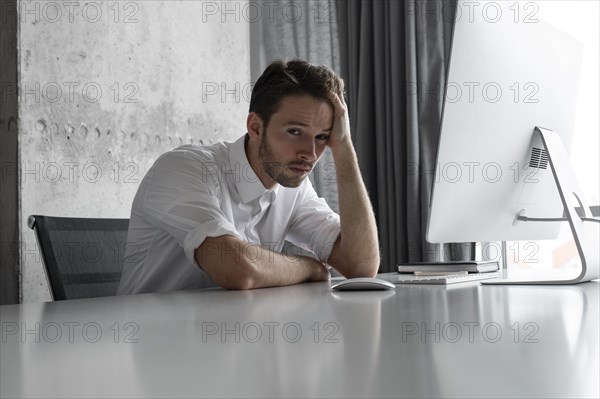 Depressed businessman sitting at desk